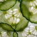 Sliced fresh cucumber close-up with intricate seed patterns.