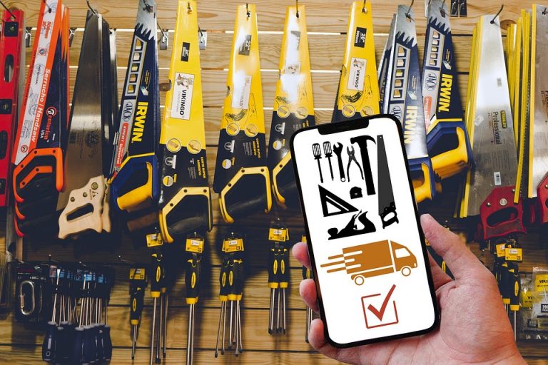 Hand holding phone with tools and delivery app in hardware store.