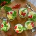 Fresh desserts garnished with red currants and basil leaves.