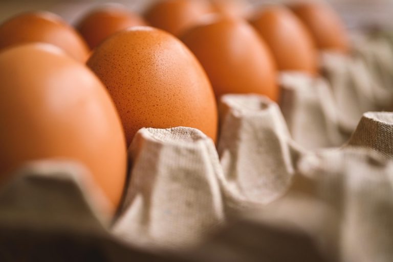 Brown eggs nestled in a carton tray, close-up view.