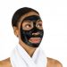Woman with black face mask and towel around neck.