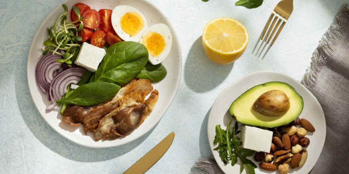 Healthy keto meal with eggs, bacon, avocado, nuts, and vegetables.