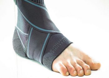 Ankle support brace on a foot providing compression.