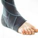 Ankle support brace on a foot providing compression.