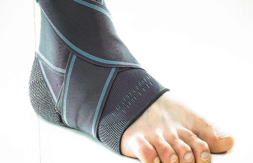 Ankle support brace on a foot providing compression.