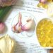 Garlic bulbs and supplement capsules on a health benefits page.