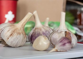 Garlic cloves on a kitchen counter for cooking.