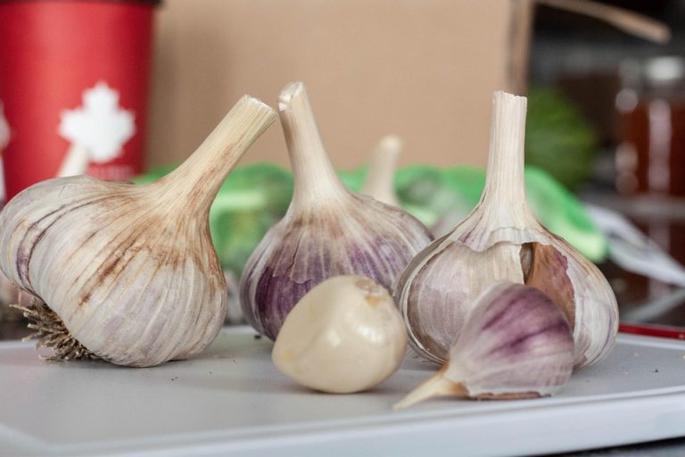 Garlic cloves on a kitchen counter for cooking.