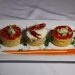 Peruvian causa with crab and avocado garnished with lobster.