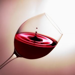 Red wine swirling in a glass, capturing elegance and rich color.