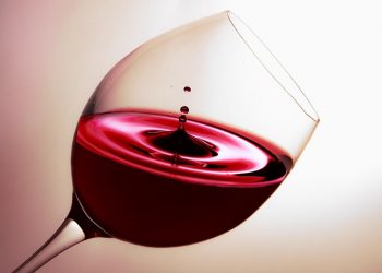 Red wine swirling in a glass, capturing elegance and rich color.