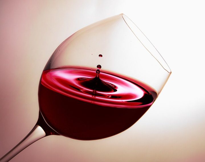Red wine swirling in a glass, capturing elegance and rich color.