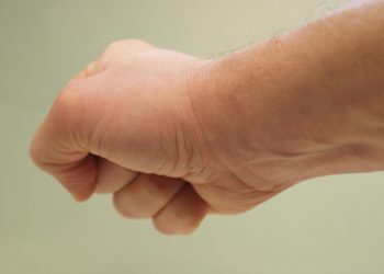 Fist clenched in a neutral background.