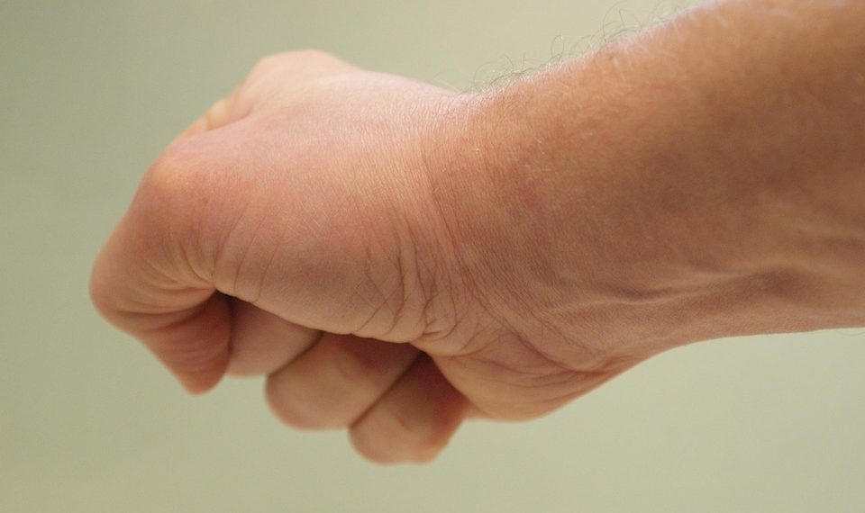 Fist clenched in a neutral background.