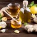 Herbal tea with ginger, garlic, lemon, and honey on a wooden table.