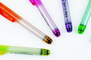 Colorful gel pens arranged in a circle pattern on a white background.