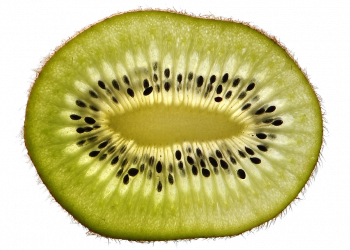 Sliced kiwi fruit with visible seeds and green flesh.