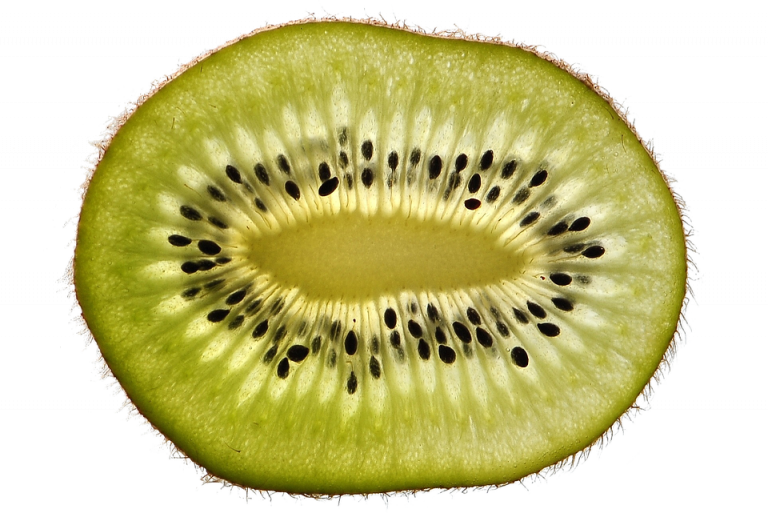 Sliced kiwi fruit with visible seeds and green flesh.