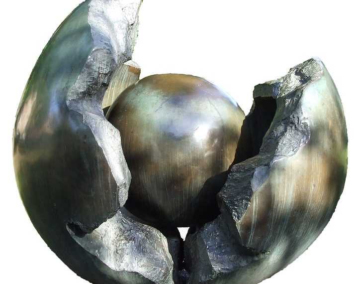 Sculpture of a metallic sphere encased in a cracked shell.