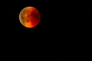 Blood Moon during total lunar eclipse in a dark night sky