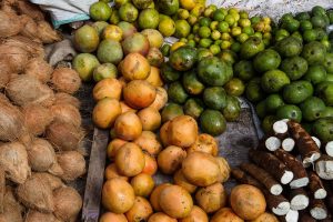 Tropical fruits and roots displayed in a vibrant market setting.