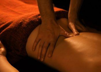 Massage therapist performing back massage therapy.