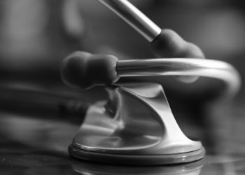 Stethoscope resting on a reflective surface for medical precision.