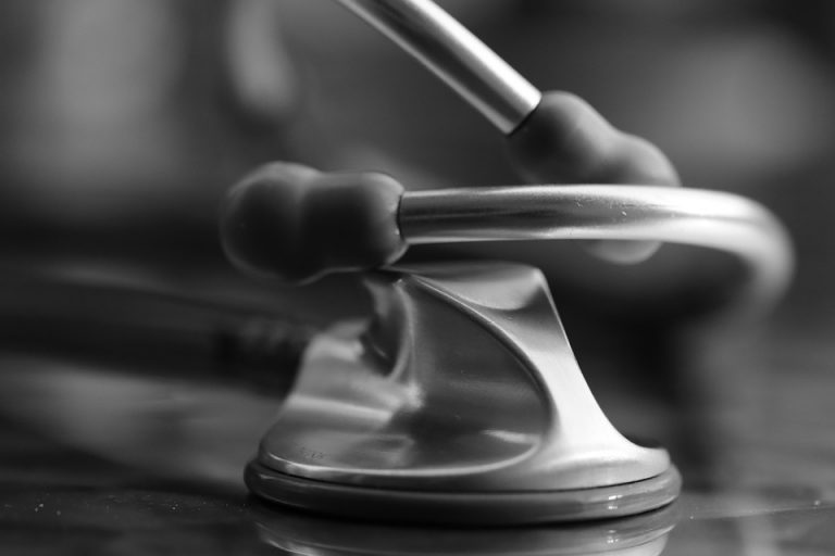 Stethoscope resting on a reflective surface for medical precision.