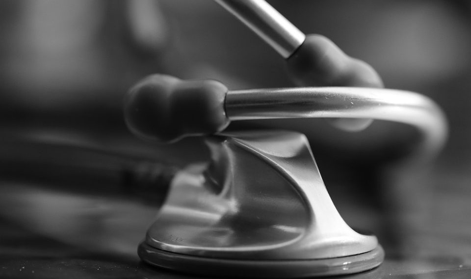 Stethoscope resting on a reflective surface for medical precision.