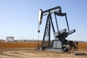 Pumpjack extracting oil on a vast field.