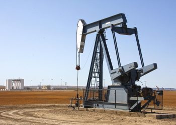 Pumpjack extracting oil on a vast field.