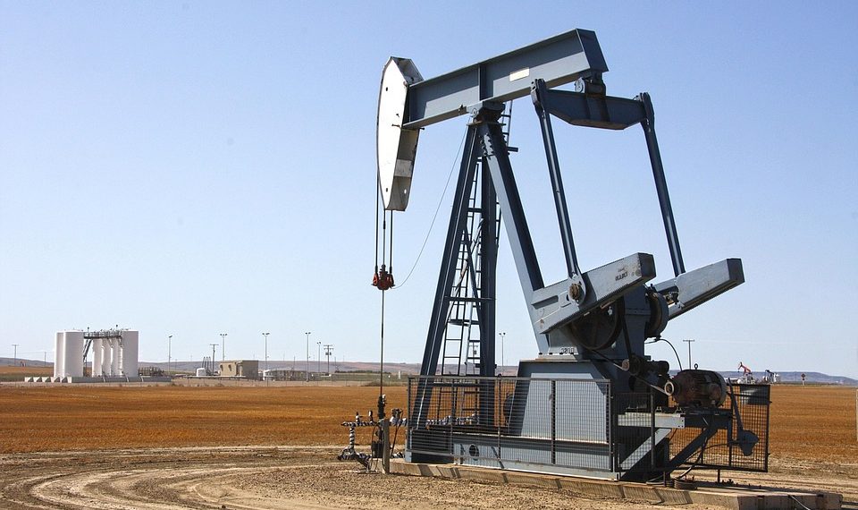 Pumpjack extracting oil on a vast field.