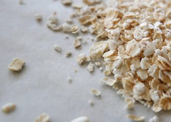 Oats scattered on a white surface.