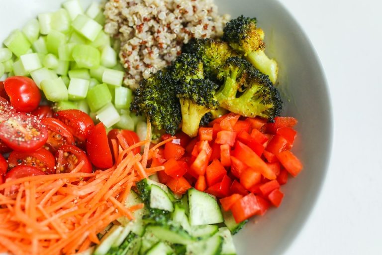 Chopped vegetables and quinoa salad in a bowl for a healthy meal.