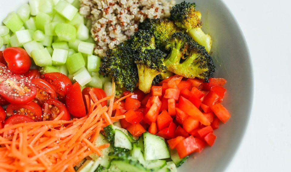 Chopped vegetables and quinoa salad in a bowl for a healthy meal.