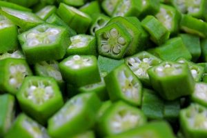 Sliced green okra pieces arranged closely together.
