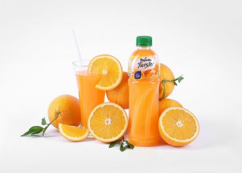 Orange juice bottle with fresh oranges and glass.