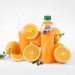 Orange juice bottle with fresh oranges and glass.