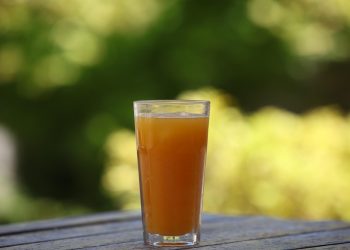 Refreshing orange juice on outdoor table.