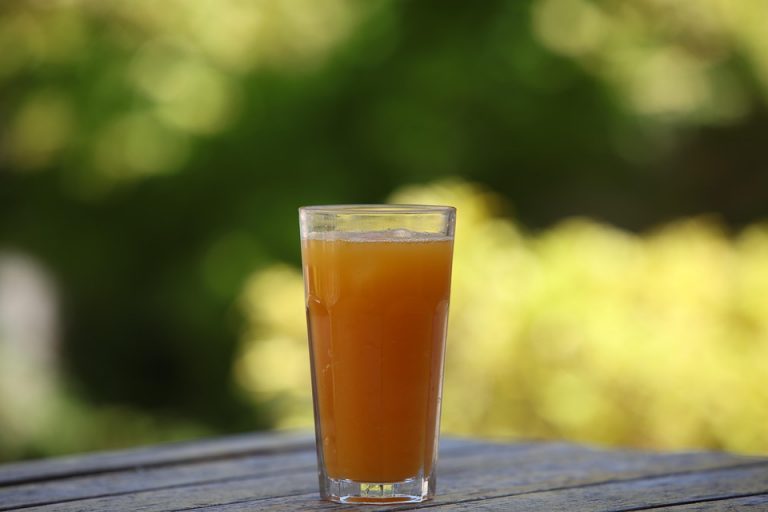 Refreshing orange juice on outdoor table.