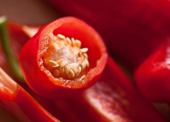 Red chili pepper with seeds visible inside.