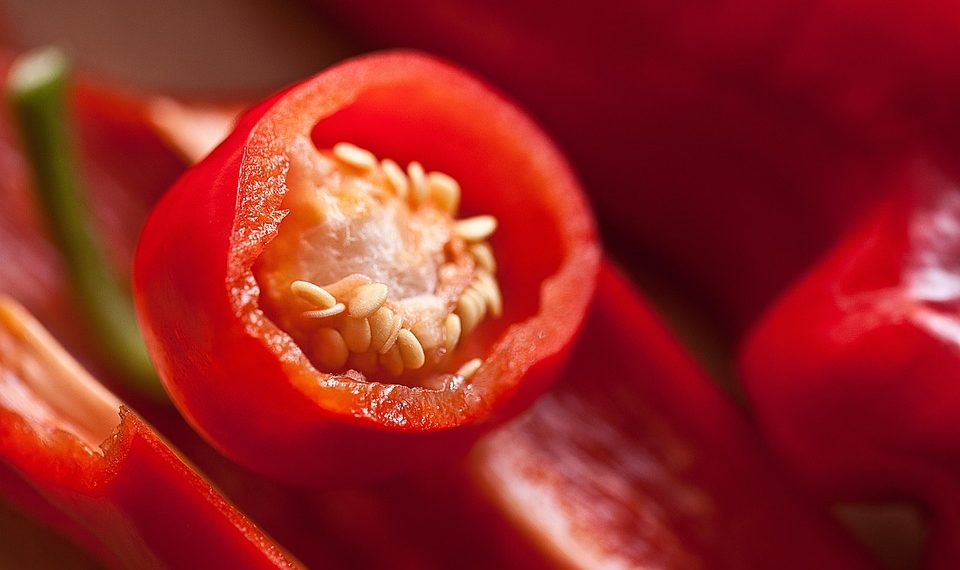Red chili pepper with seeds visible inside.