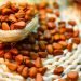 Pine nuts scattered on a woven mat.