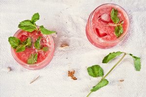 Refreshing watermelon mint drinks with ice cubes.
