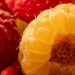 Yellow and red raspberries in close-up with detailed textures.