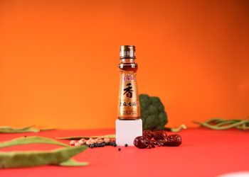 Soy sauce bottle with ingredients on bright background.