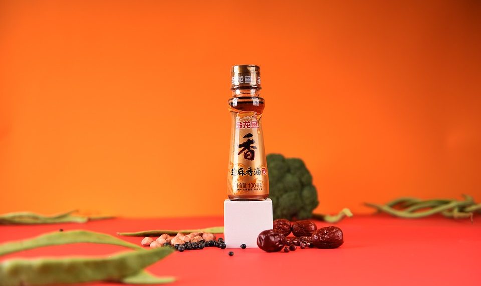 Soy sauce bottle with ingredients on bright background.