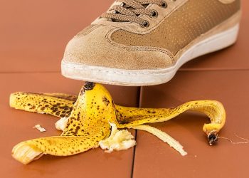 Shoe about to step on a banana peel, creating a potential slip hazard.