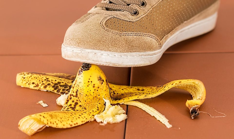 Shoe about to step on a banana peel, creating a potential slip hazard.