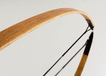 Wooden recurve bow detail with smooth curve design.